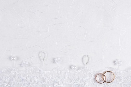 space for text and weddings accessories on white silkの写真素材