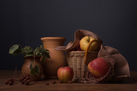 Red fresh apples in a wicker basketの写真素材
