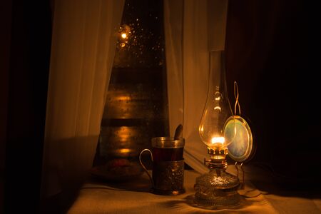 Still life with kerosene lamp near the windowの写真素材
