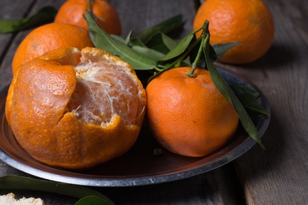Ripe fresh tangerines on a old wooden tableの写真素材