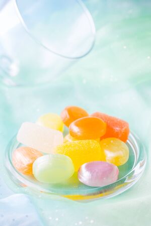 Different colors lollipops lying on the fabricの写真素材