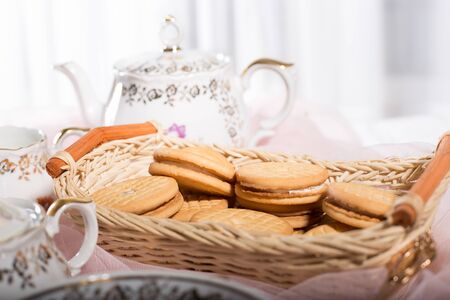 Morning tea concept with cup of tea, milk and biscuitの写真素材