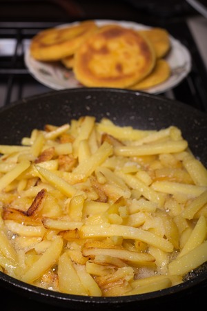 process of making fried potato on the home kitchenの写真素材