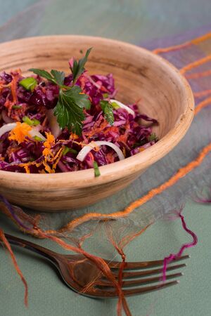 Salad of fresh blue cabbage in a ceramic plateの写真素材