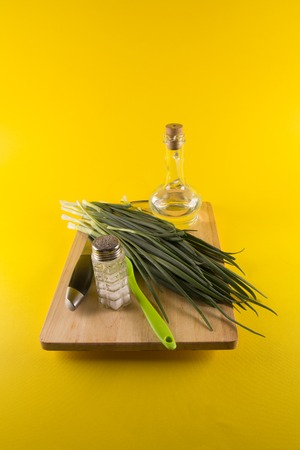 Fresh green onion on a cutting boardの写真素材