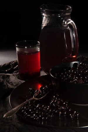 Black currant berries and drink from itの写真素材