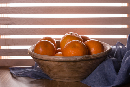 Tangerines or oranges, mandarins, clementines, citrus fruits on a wooden tableの写真素材
