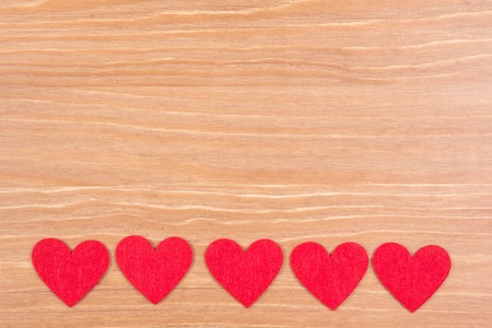 Valentine's day background with heart shapes on wooden tableの写真素材