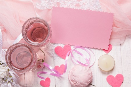 White wooden background with pink and white objects