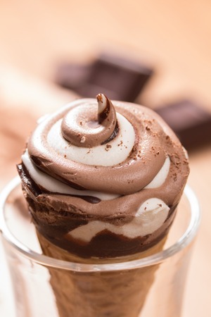 ice cream and pieces of dark chocolate on the tableの写真素材