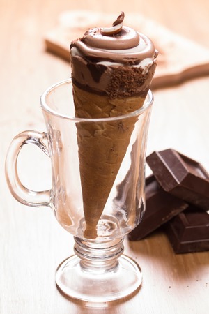 ice cream and pieces of dark chocolate on the tableの写真素材