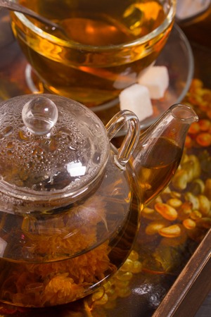 Green tea with jasmine and chrysanthemum in a teapotの写真素材