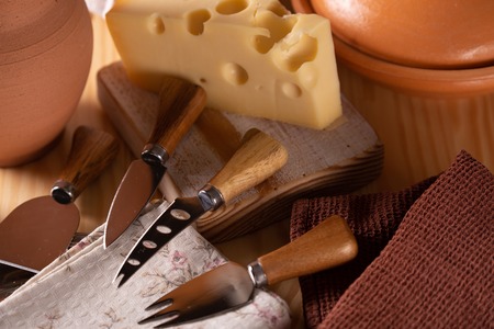 A piece of fresh tasty cheese on the kitchen tableの写真素材