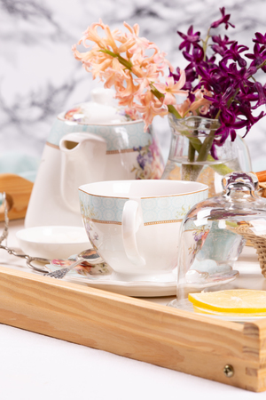 Morning tea concept with cup of tea, teapot and strudelの写真素材