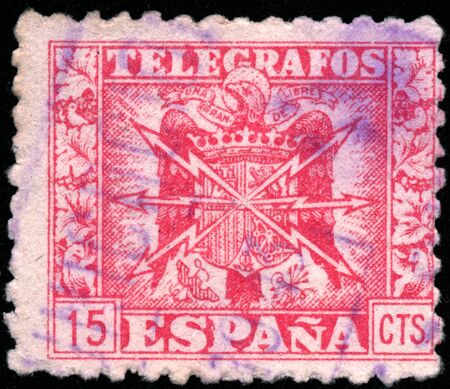 POLTAVA, UKRAINE - SEPTEMBER 23, 2019. Vintage stamp printed in in Spain 1940 shows coat of arms and the word telegrafosのeditorial素材