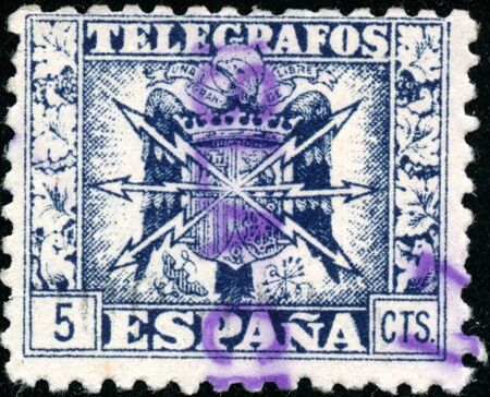 POLTAVA, UKRAINE - SEPTEMBER 23, 2019. Vintage stamp printed in in Spain 1940 shows coat of arms and the word telegrafosのeditorial素材
