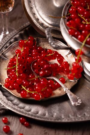 Fresh, ripe berries of red currant on a vintage tablewareの写真素材