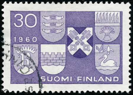 POLTAVA, UKRAINE - January 16, 2020. Vintage stamp printed in Finland circa 1960 show coats of arms six new townsのeditorial素材