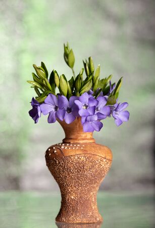 Bunch of beautiful spring flowers in a vase on a bokeh backgroundの写真素材