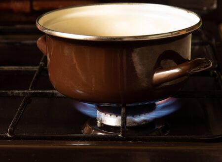 Brown pan is heated on a gas stoveの写真素材
