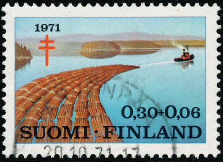 POLTAVA, UKRAINE - May 15, 2020. Vintage stamp printed in Finland circa 1971 show prevention of tuberculosis - Timber Industryのeditorial素材