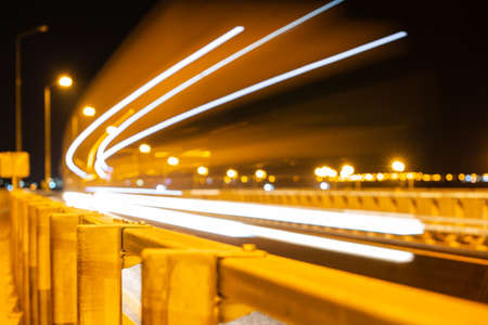 The trail from the headlights of a passing car on the night road on a long exposure