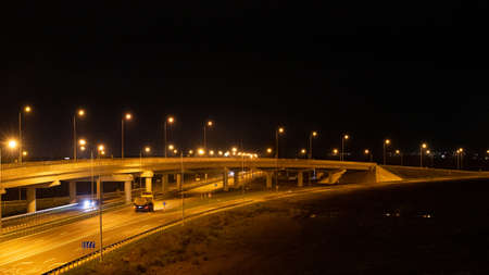 The trail from the headlights of a passing car on the night road on a long exposure