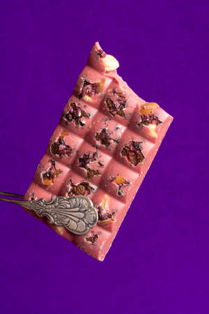 Delicious pink chocolate with nuts and fruits
