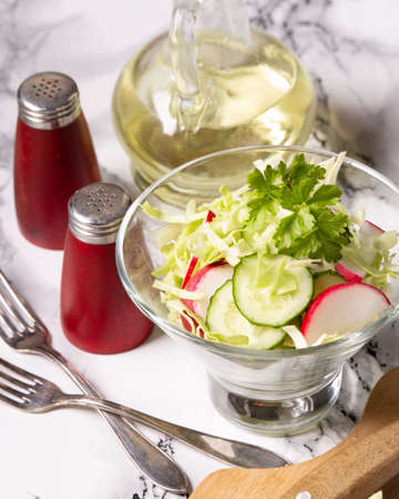 Homemade fresh vegetable salad in a glass bowlの写真素材