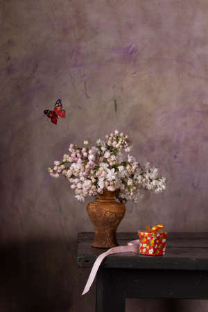 Still life with a bouquet of white lilacs on the tableの写真素材