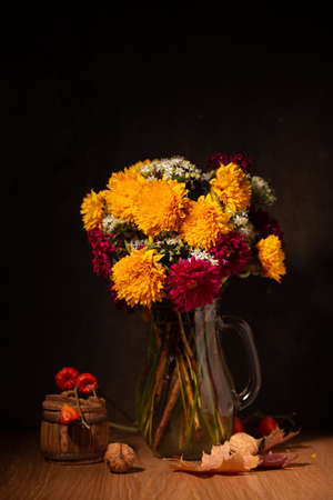Classic still life with a bouquet of autumn flowers n a darkの写真素材
