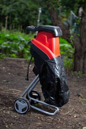 Garden chipper, electric shredder mulcher against the background of the gardenの写真素材