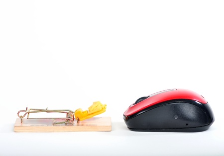mouse trap facing a computer mouseの写真素材