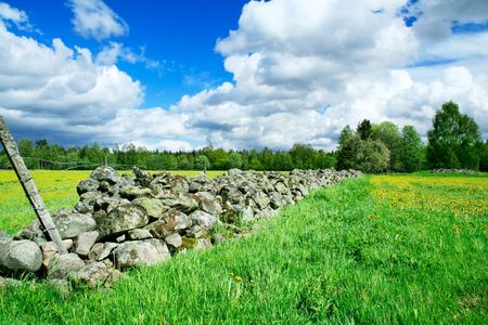 A stone fence separating farm groundsの写真素材
