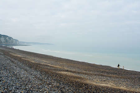 Pebble beach and shoreline at the Alabaster Coast in Dieppe, France. Quiet melancholic day in October.の写真素材