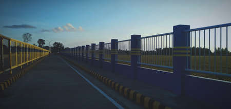 3d rendering of a bridge over the river in the evening.