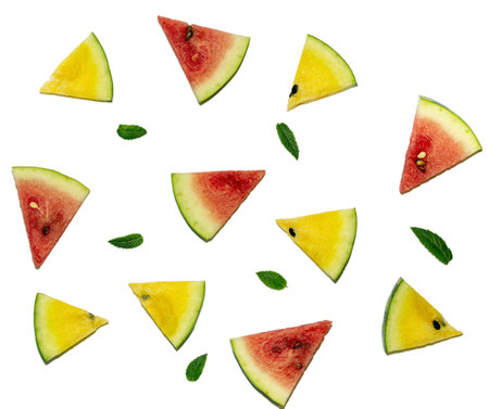 Sliced red and yellow watermelons with leaves of mint on a white background