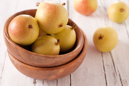 Sweet yellow pear in the wood bowlの写真素材