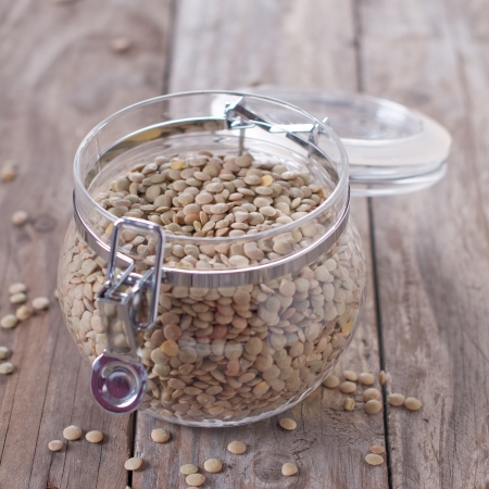 Dried raw lentil on the wooden table, square imageの写真素材