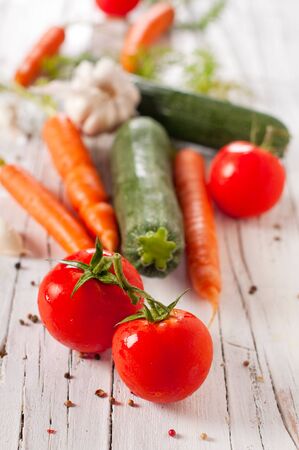 Raw carrot, tomato, garlic and zucchini, selective focusの写真素材