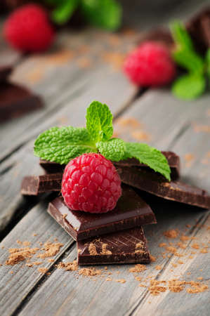 Dark chocolate with mint on the vintage table, selective focus
