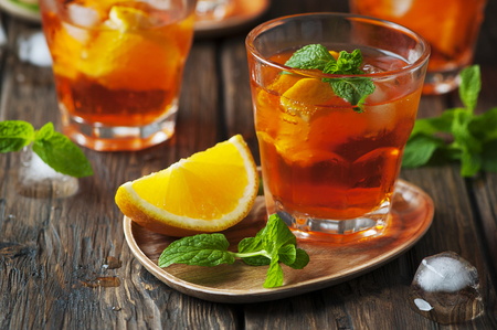 Glass of aperol with ice, orange and mint, selective focusの写真素材