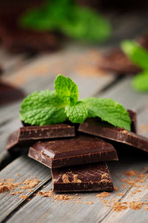 Dark chocolate with mint on the vintage table, selective focusの写真素材