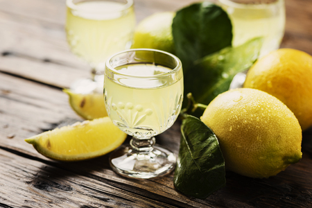 Italian typical digestive limoncello with fresh lemons, selective focusの写真素材