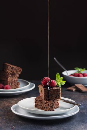 Chocolate cake with caramel, raspberry and mint, selective focus imageの写真素材