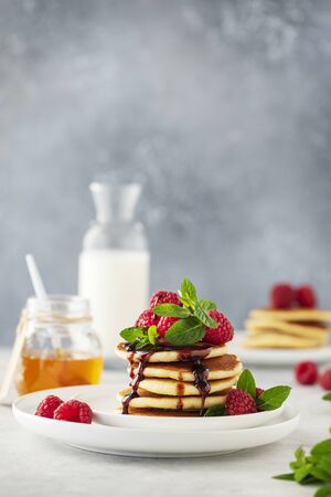 Sweet pancakes with raspberry, mint and caramel, selective focus imageの写真素材
