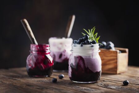 Sweet healthy yogurt with blueberry on the wooden table, rustic stileの写真素材