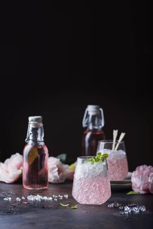Pink cocktail with mint and crushed on the black background, selective focus imageの写真素材