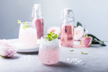 Pink cocktail with crushed ice and mint on the light background, selective focus imageの写真素材