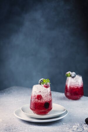 Summer cocktail with raspberry, blackberry, ice and mint, selective focus imageの写真素材
